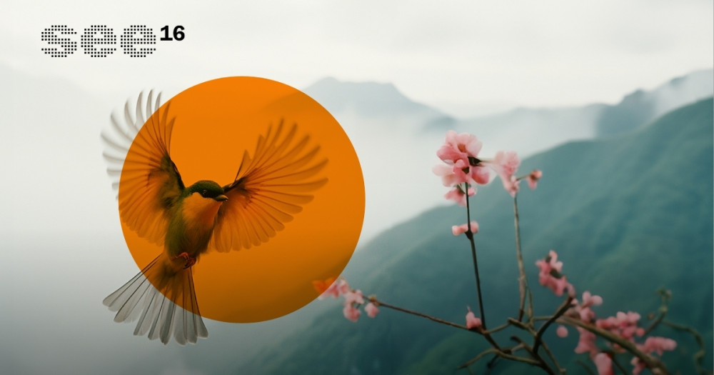 Ein Vogel in einem orangenen Kreis im Landeanflug auf eine rosa Blüte